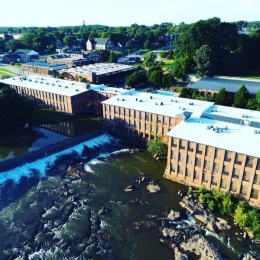 Love where you live aerial view of large building next to a river