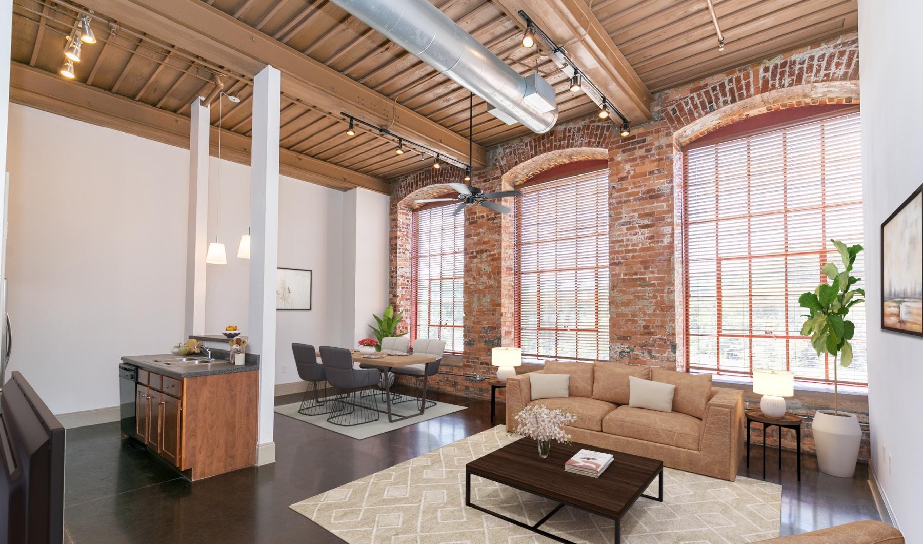 a living room with a large brick wall and a large window