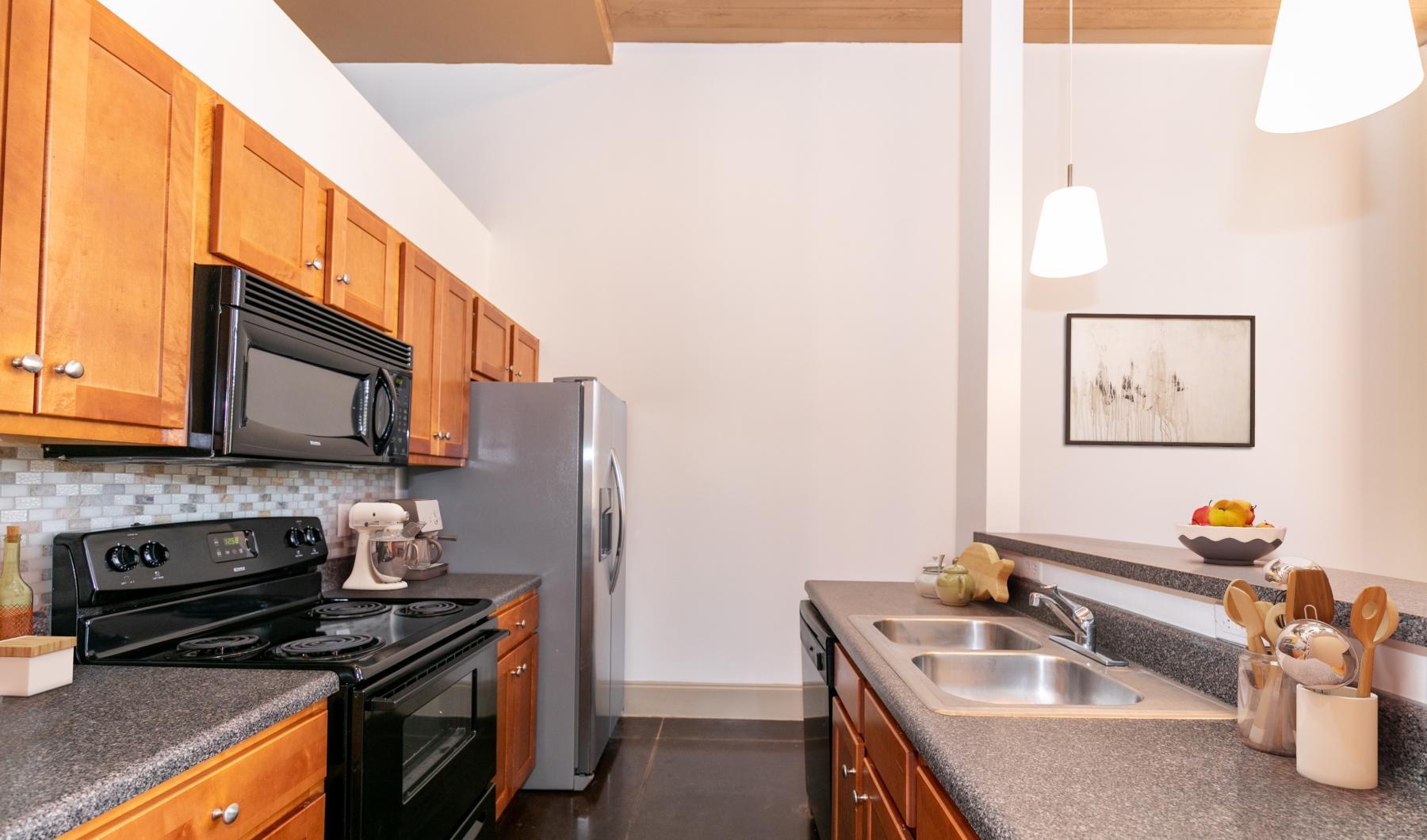 Spacious kitchens with thoughtful details a kitchen with black appliances