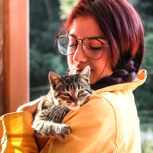 a woman holding her cat